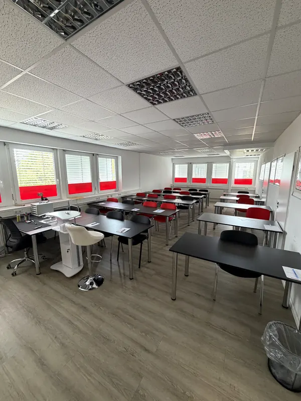 Classroom with the instructor's desk on the left and long rows of desks