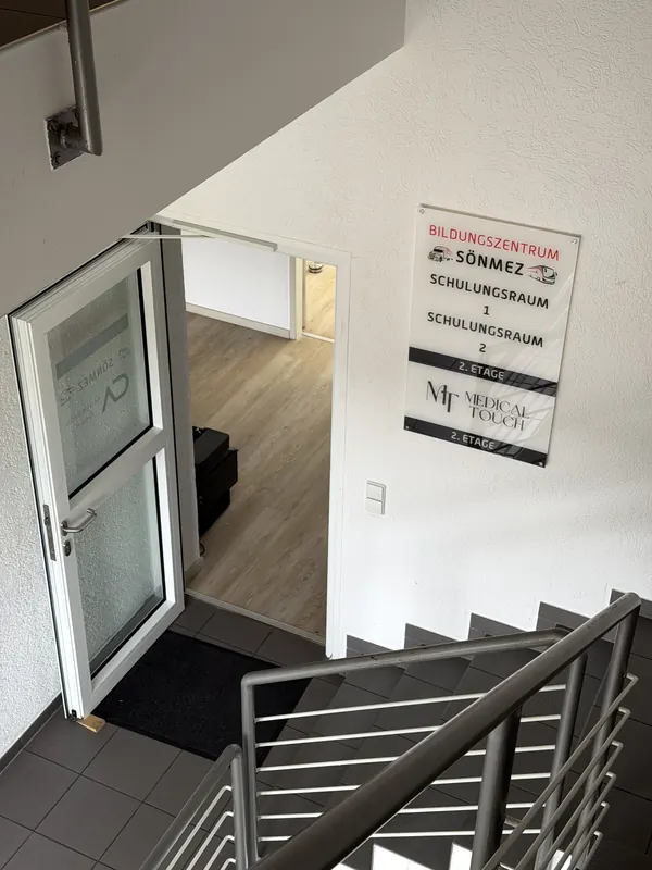 Stairwell with a sign to classrooms 1 and 2